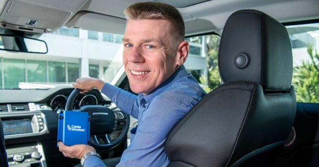 Paul Gray in car with Cohda Wireless tech