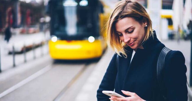 young woman checking app public transport